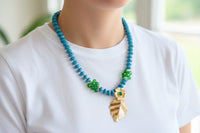Turquoise Beaded Statement Necklace with Gold Flower & Leaf Pendant